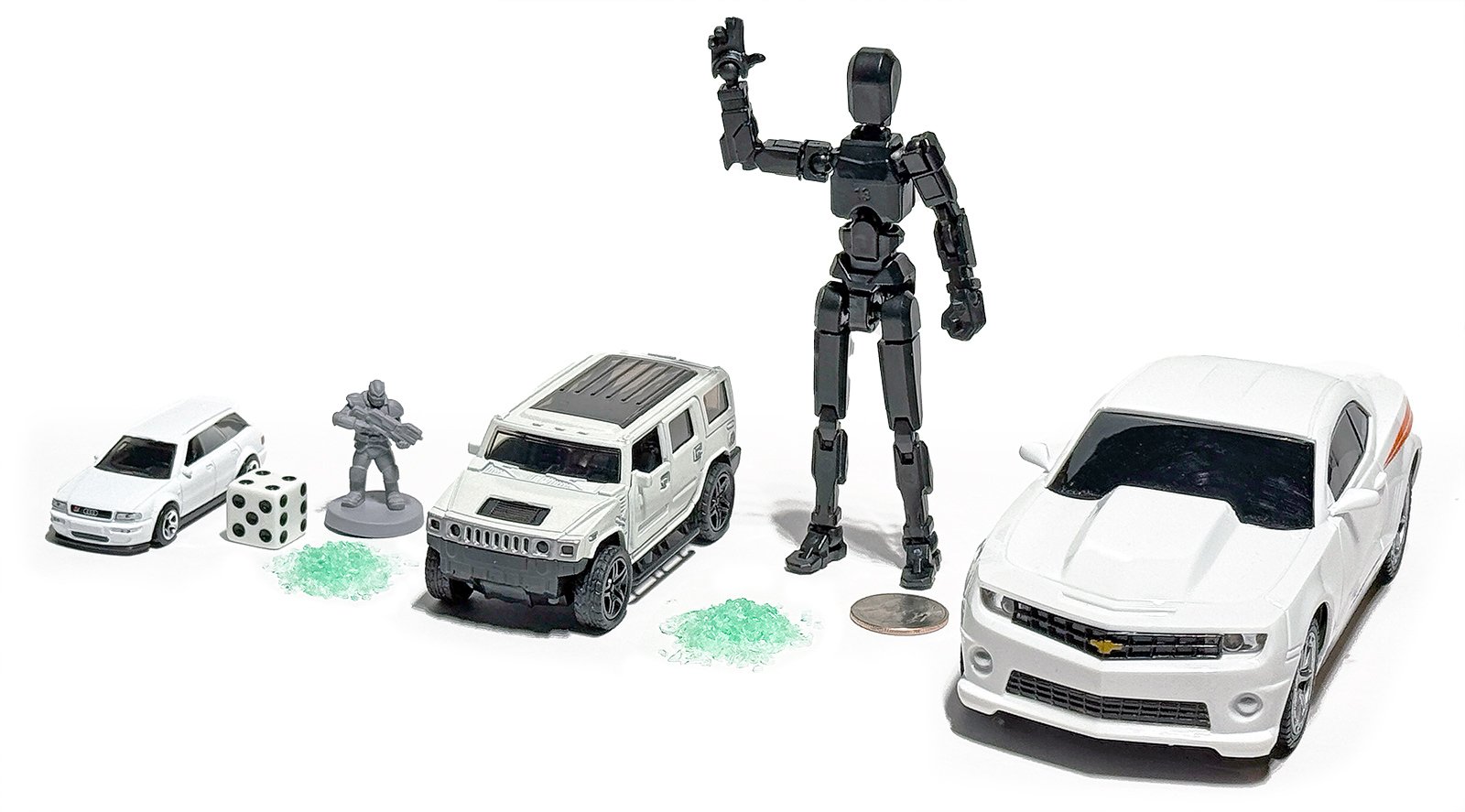 scale_reference_shatter scale model reference photo showing shatter next to various props (die cast cars, tabletop figurine, 1/12 scale figure, US quarter)
